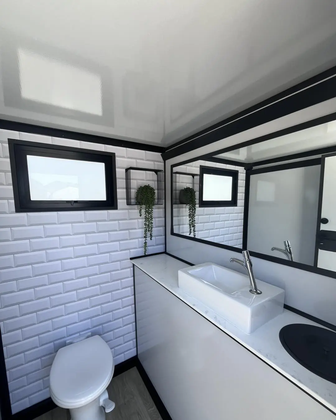 Tiled floor and walls inside a restroom trailer stall