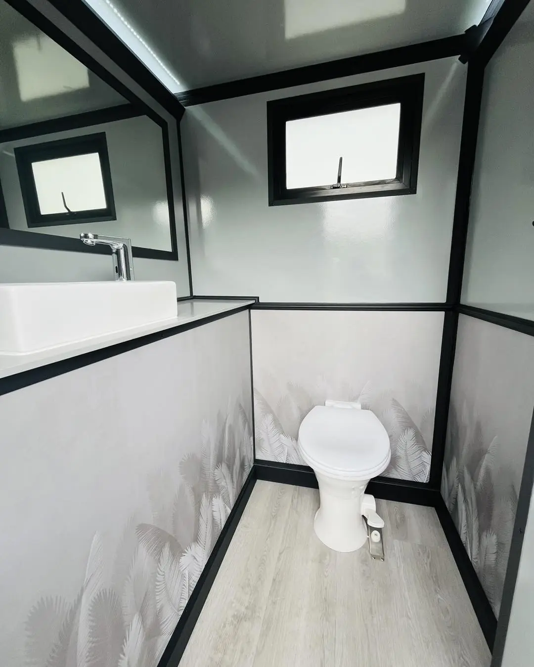 Restroom trailer room with a window letting in daylight